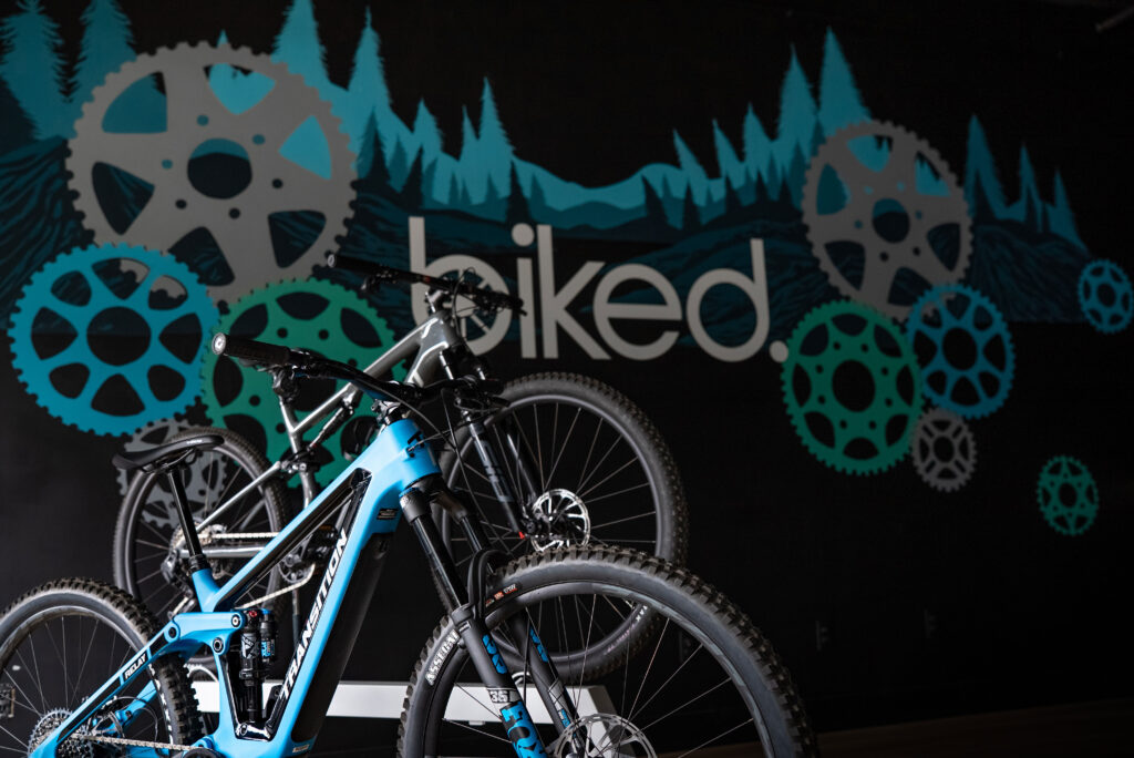 Transition and Specialized bikes in front of mural at Biked’s bike shop, ready for pickup