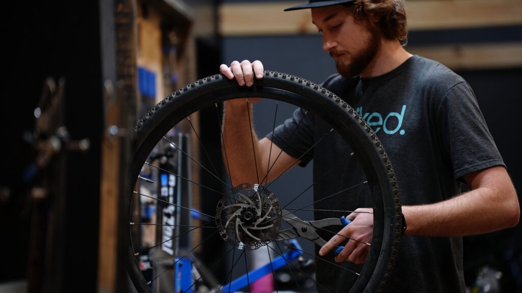 Bike technician repairing MTB suspension in Grand Rapids MI